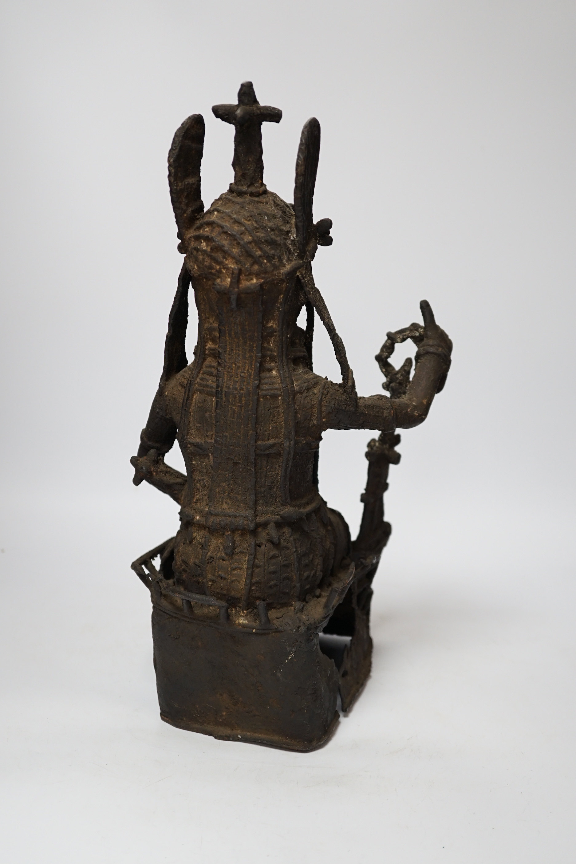 A 19th century Benin bronze of a seated figure, 38cm high